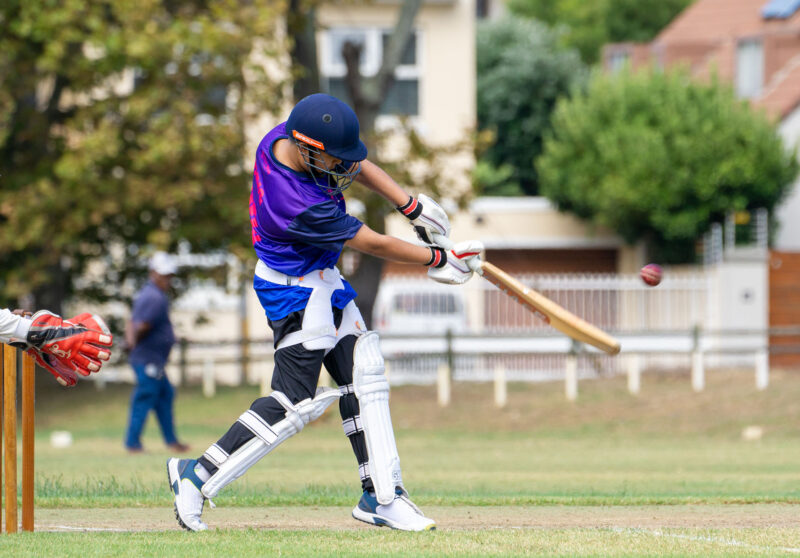 A boy playing cricket