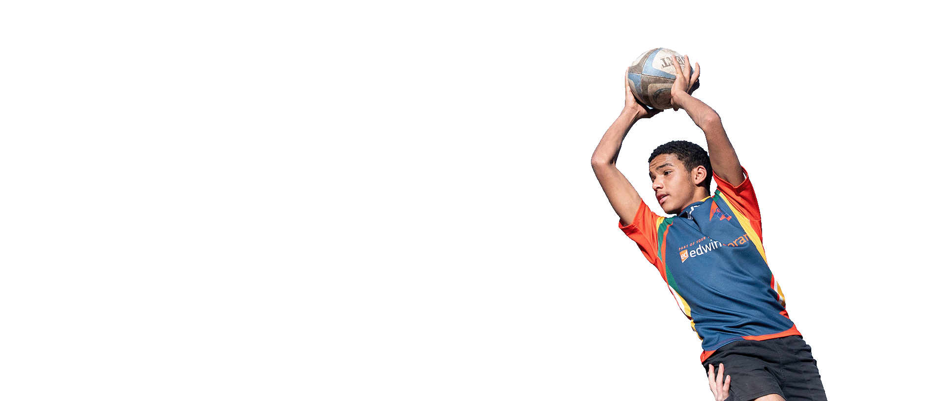 Rugby player jumping with a ball