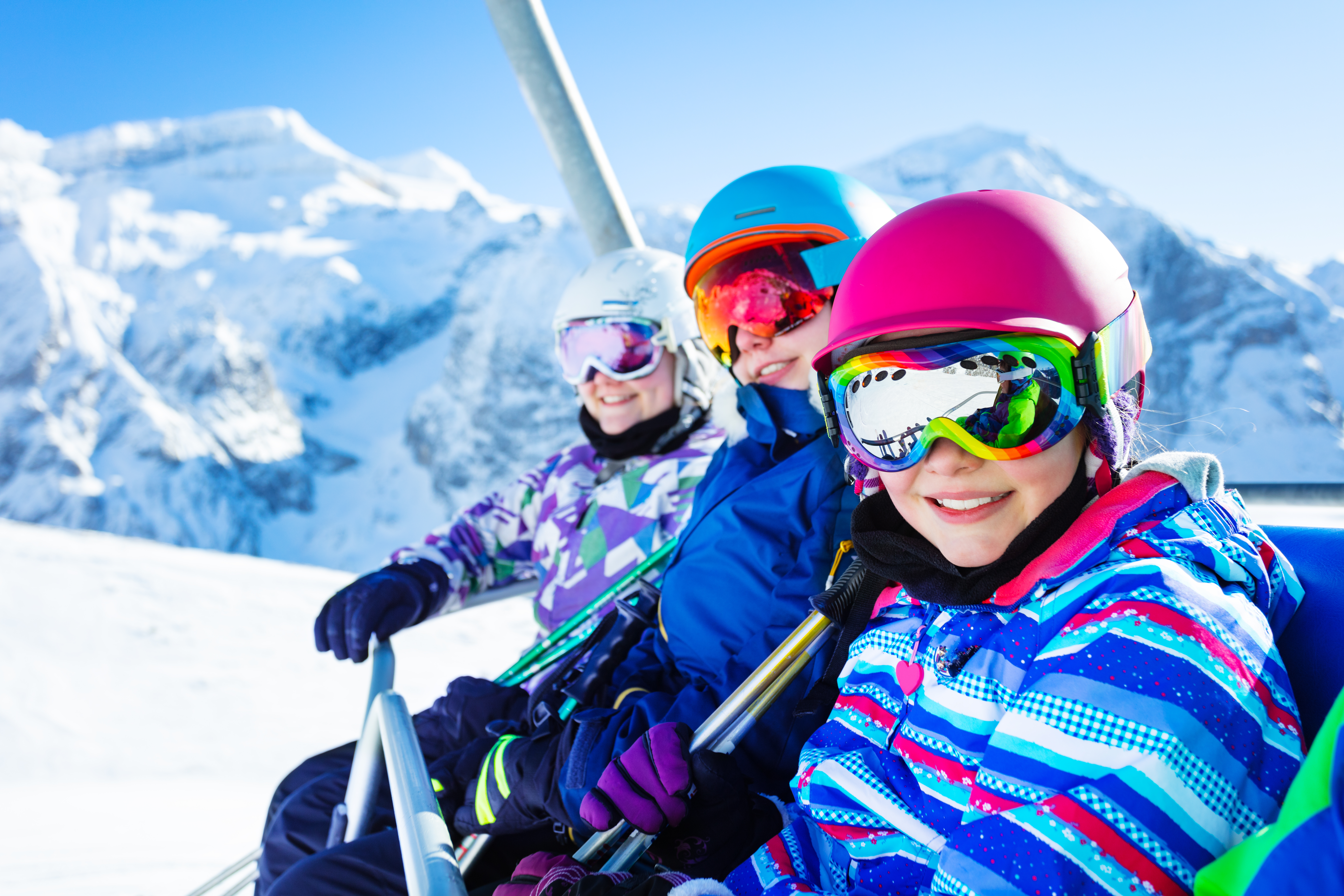 Smiling students on a ski lift